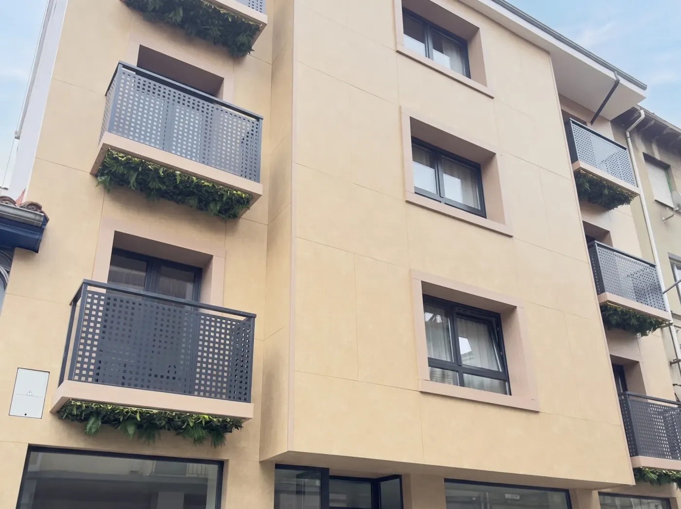 Detail of the hotel façade with balconies and planters