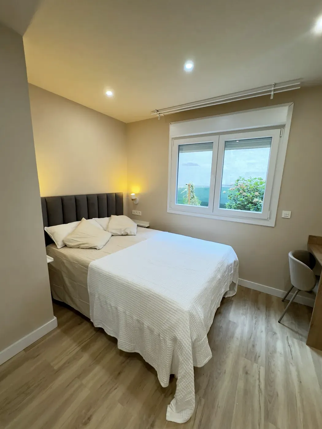 Bedroom of the ground-floor step-free room with a double bed and window